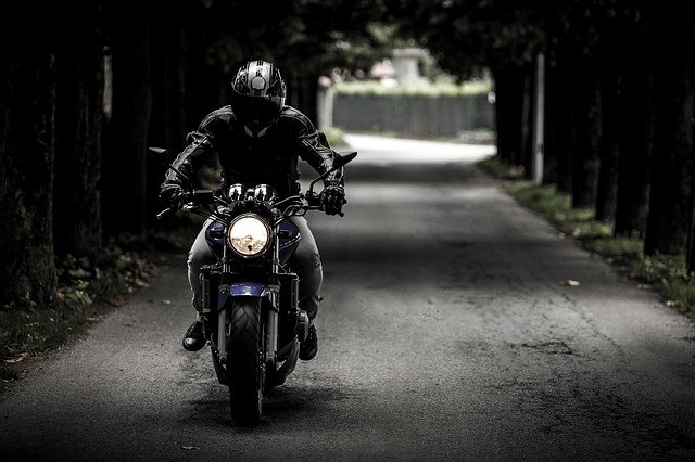 motorcycle rider dark background