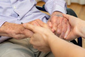 holding senior citizen's hands